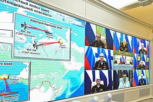 Obraz pokazywany na wyświetlaczach w ośrodku sytuacyjnym na Kremlu. Widać wizualizację ataku pociskami Kinżał wystrzeliwanych z samolotów MiG-31I do celów lądowych i morskich, a także atak pociskami samosterującymi Kalibr wystrzeliwanymi z korwety rakietowej Floty Czarnomorskiej Grajworon. Na prawym ekranie minister Szojgu i dowódcy odpowiedzialni za przebieg ćwiczeń oraz obserwujący ich działania prezydenci Putin i Łukaszenko / Zdjęcie: MO FR