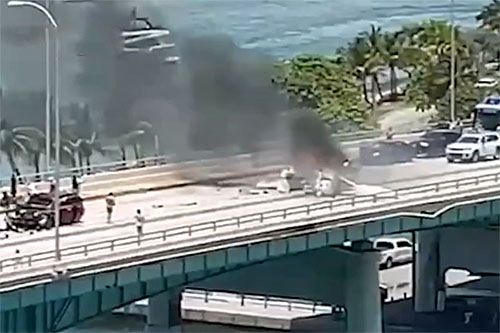 Płonący wrak samolotu Cessna 172, który zderzył się z samochodem podczas awaryjnego lądowania na moście Haulover Inlet w Miami / Zdjęcie: Twitter
